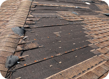 a damaged shingle roof in brown