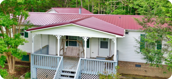 an aerial view of a red metal roof on a house
